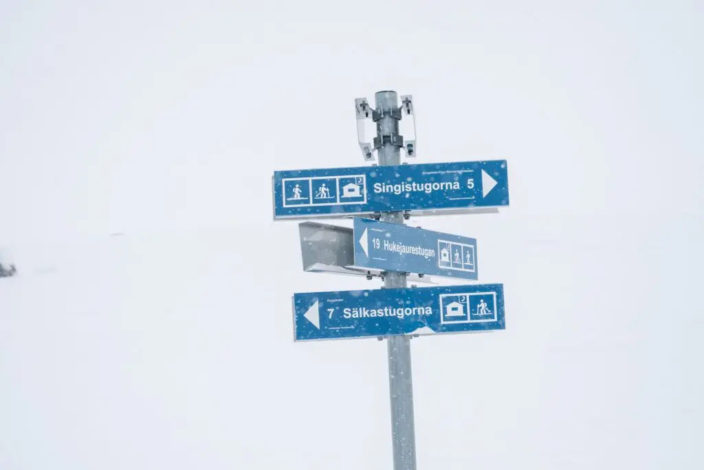Blue trail signs in snowy Swedish Lapland